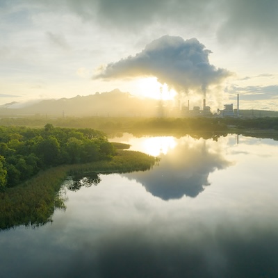 Aerial view coal power plant station in the morning mist, the morning sunrises. coal power plant and environment concept. Coal and steam. Mae Moh, Lampang, Thailand.