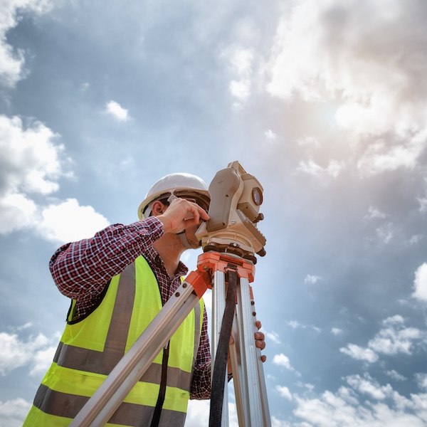 Surveyor equipment. Surveyor’s telescope at construction site or Surveying for making contour plans are a graphical representation of the lay of the land before startup construction work