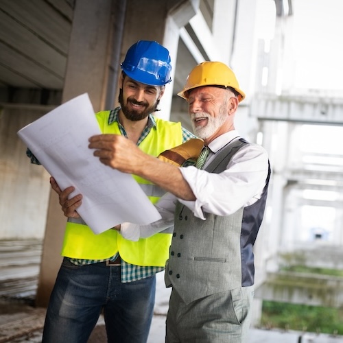 Construction engineers discussion with architects at construction site or building site